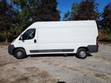 a white van parked in a lot with trees in the background