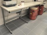 an image of a kitchen with a table and two barrels