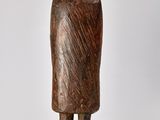 wooden statue of a man with a hat and coat on a base