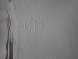 embroidered monogram on a white shirt with the letter cm on it