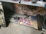 a picture of a garage with a bunch of tools on the floor
