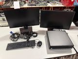 two computer monitors and a keyboard on a desk