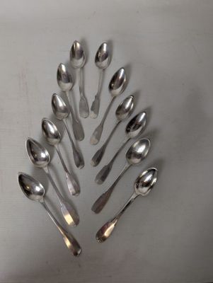 a lot of spoons arranged in a circle on the table