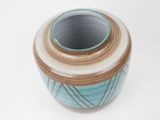 a small blue and brown vase on a white surface