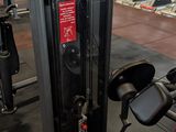 a gym room with a row of machines in it