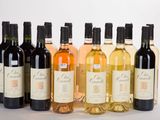 several bottles of wine sitting next to each other on a table