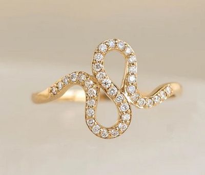 a close up of a gold ring with diamonds on it