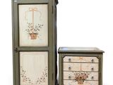 an image of a cabinet and a chest of drawers with flowers painted on them