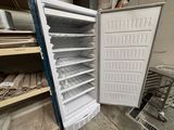 a white refrigerator with its door open in a room