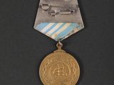 an image of a medal with a picture of a plane on it