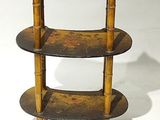 a small wooden shelf with three shelves on it