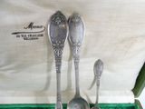three spoons and two spoons sitting in a box