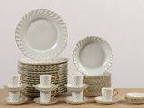 a stack of plates and cups on a table
