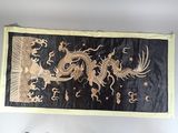 a black and gold dragon banner hanging on the wall