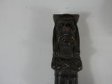 a statue of a man with a beard on a white wall