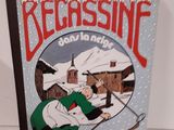 un livre sur lequel figure la photo d'un homme faisant du ski dans la neige