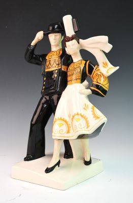a figurine of a man and a woman dressed in costumes