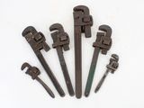 six old pipe wrens are lined up on a white surface
