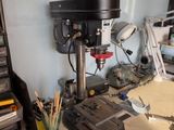 a workbench with a drillet and a lot of tools on it