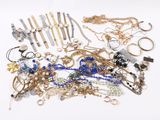 a pile of jewelry on a white surface