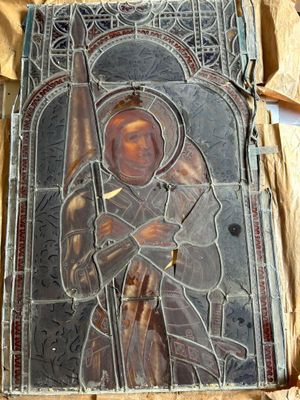an image of a stained glass window with a man holding a sword