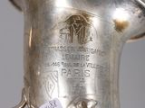 a silver vase that has a tag on it