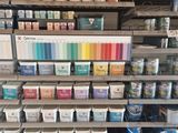 the shelves are full of paint and supplies in the store