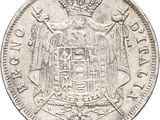 a close up of a silver coin with a crown on it