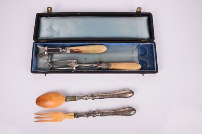 three forks and spoons in a case on a table