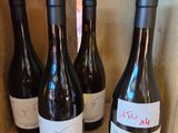 several bottles of wine are lined up in a wooden box