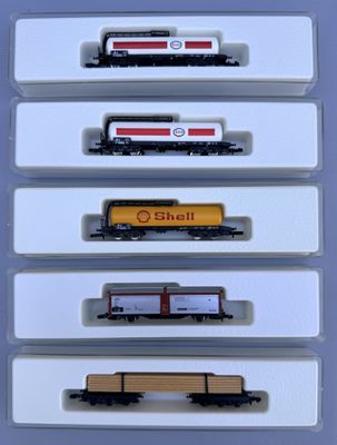 five train cars that are on display in a display case