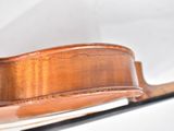 a close up of a violin on a white surface