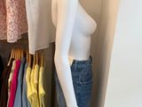 a mannequin in a closet with clothes on hangers
