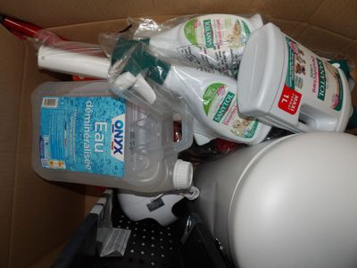 a box full of toothbrushes, toothpaste, and other hygiene products