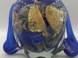 a blue vase with a gold leaf decoration on it