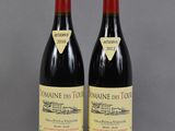 two bottles of wine sitting on top of a table next to each other
