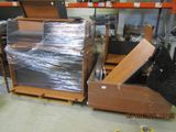 a large pile of furniture in a warehouse with plastic wrap around it