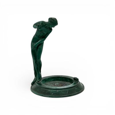 green statue of a man holding a golf club on a white background