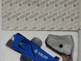 a small blue tool in a box on a table