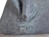 statue of a man with a hat on his head on a square base