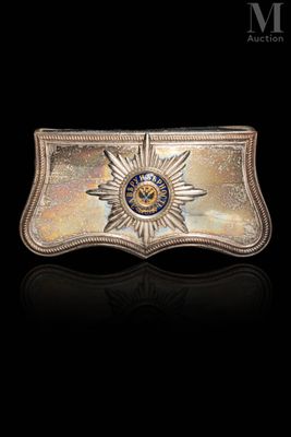 a close up of a metal belt buckle with a star on it