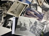 several old black and white photos of people and buildings on a table