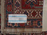a close up of a rug with a tag on it