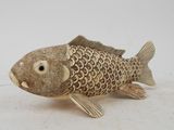 a small wooden fish that is sitting on a table