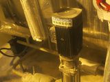 pipes and valves in a room with a red valve
