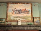 a picture of a painting on the wall above a fireplace