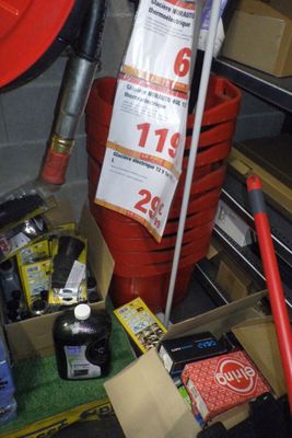 un seau rouge rempli d'objets divers dans un garage