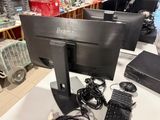 a computer monitor and keyboard on a table in a store