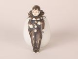 a small figurine of a woman in a black and white outfit