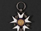 an image of a medal with a star on it on a black surface